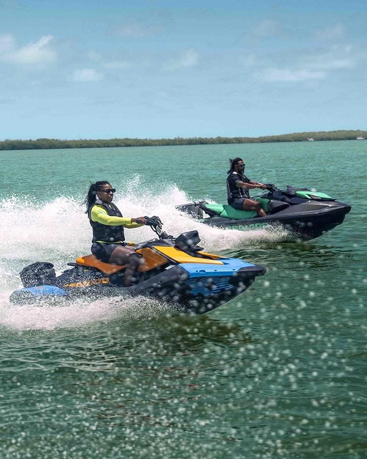 Two riders on Sea-Doo jet skis racing across turquoise water off Mombasa